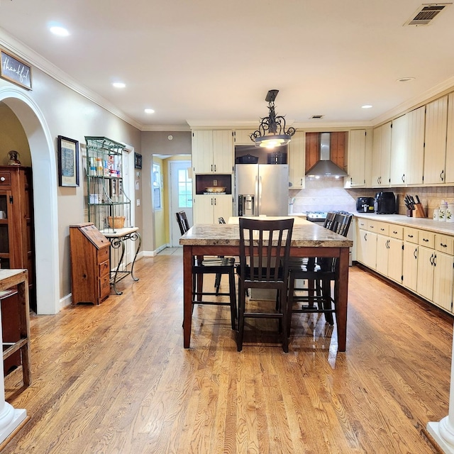 dining space featuring light hardwood / wood-style floors and ornamental molding