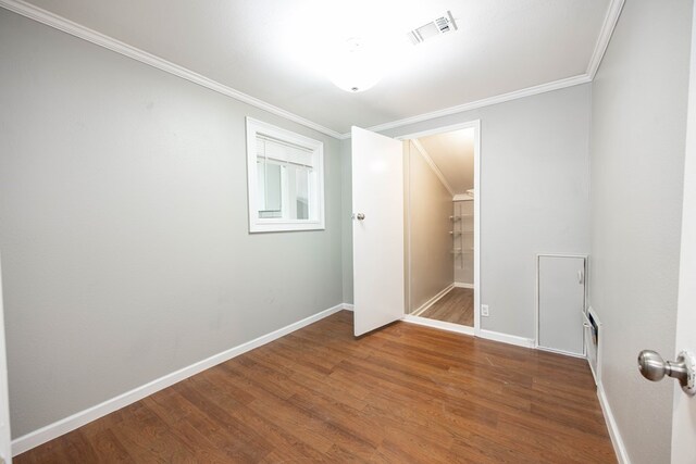 646 Byrd Ave, Smiths Station, AL 36877 - spare room featuring ornamental molding, visible vents, and wood finished floors