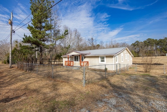 646 Byrd Ave, Smiths Station, AL 36877 - view of side of home featuring metal roof and a fenced front yard