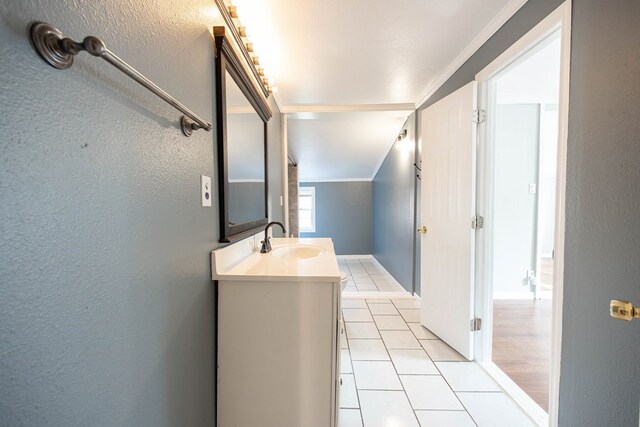 646 Byrd Ave, Smiths Station, AL 36877 - bathroom with crown molding, vanity, a textured wall, and tile patterned floors