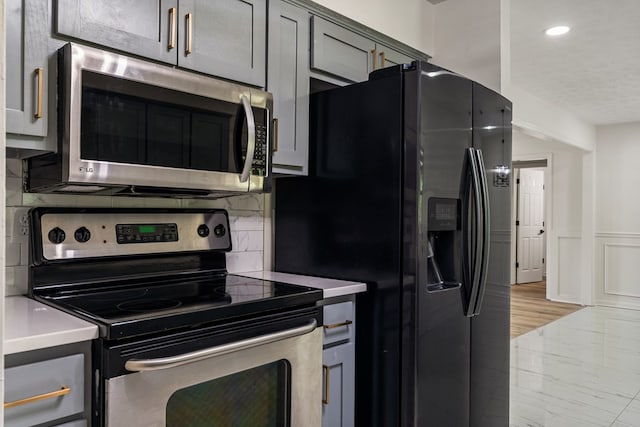 766 Lee Road 0553, Phenix City, AL 36870 - kitchen with appliances with stainless steel finishes, light countertops, recessed lighting, wainscoting, and decorative backsplash