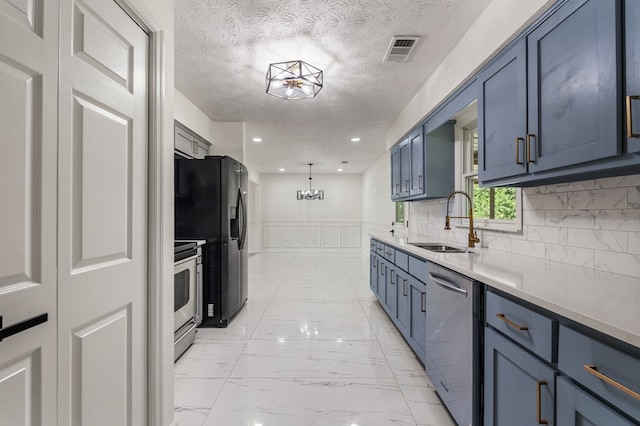 766 Lee Road 0553, Phenix City, AL 36870 - kitchen with stainless steel appliances, light countertops, a wainscoted wall, light marble finish floors, and blue cabinets