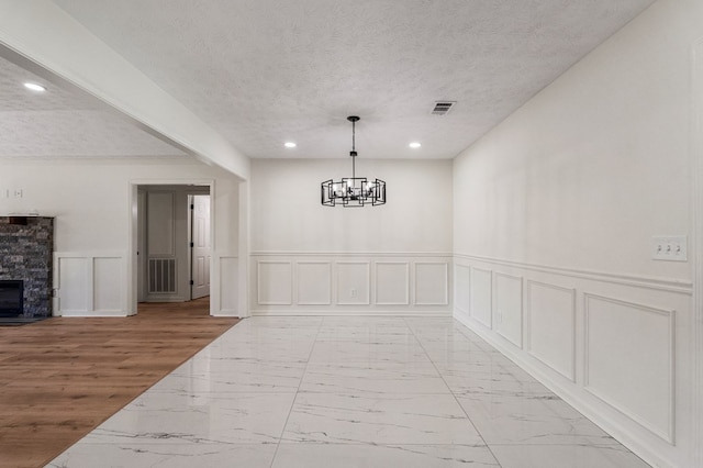 766 Lee Road 0553, Phenix City, AL 36870 - corridor with light marble finish floors, a decorative wall, recessed lighting, wainscoting, and a chandelier