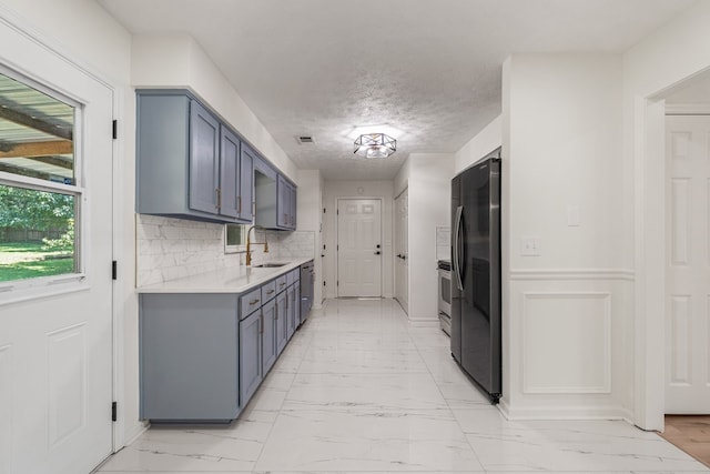 766 Lee Road 0553, Phenix City, AL 36870 - kitchen with appliances with stainless steel finishes, light countertops, light marble finish flooring, backsplash, and gray cabinets