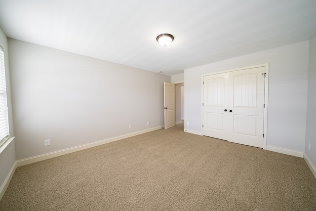 unfurnished bedroom with carpet and a closet