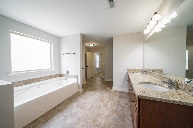 bathroom with vanity and a bath