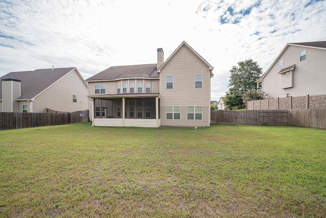 back of property featuring a sunroom and a yard