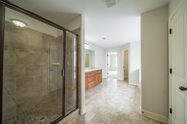 bathroom featuring vanity and a shower with shower door