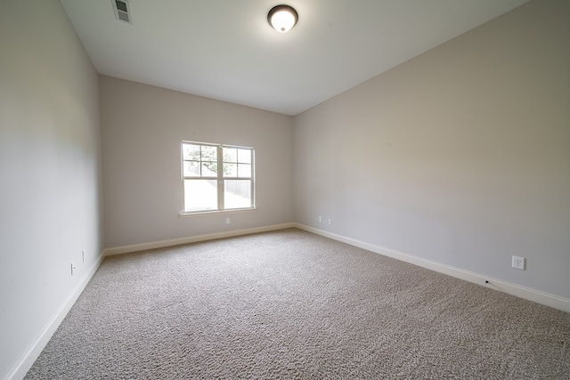 unfurnished room with carpet and vaulted ceiling