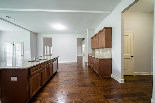 kitchen featuring dishwasher, sink, dark hardwood / wood-style floors, an island with sink, and light stone counters