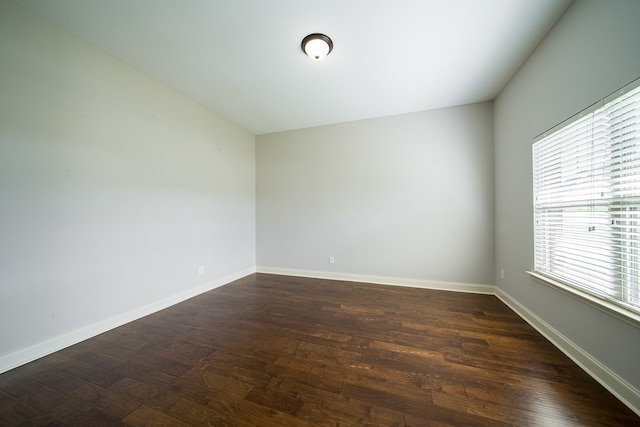 empty room featuring dark wood-type flooring