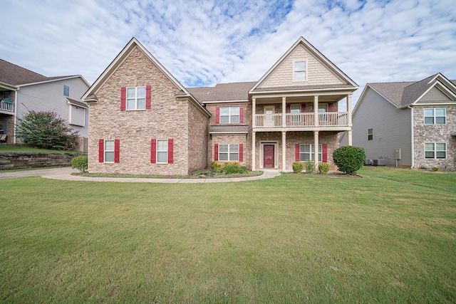 craftsman-style home with a balcony, central AC unit, and a front lawn