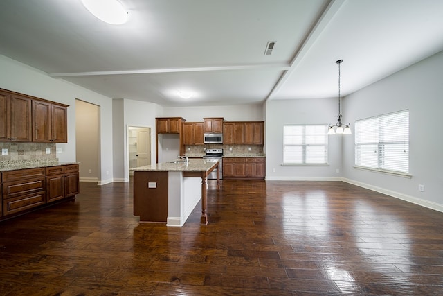 kitchen featuring dark hardwood / wood-style floors, stainless steel appliances, and tasteful backsplash