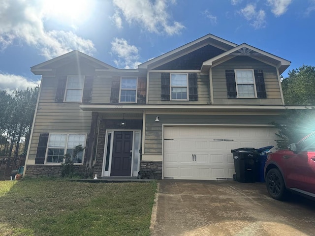 view of front of home with stone siding, driveway, an attached garage, and a front yard