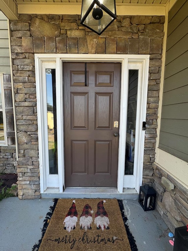 property entrance featuring stone siding