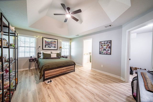 5082 Aaron Ln, Columbus, GA 31907 - bedroom with a tray ceiling, light wood-type flooring, and a ceiling fan
