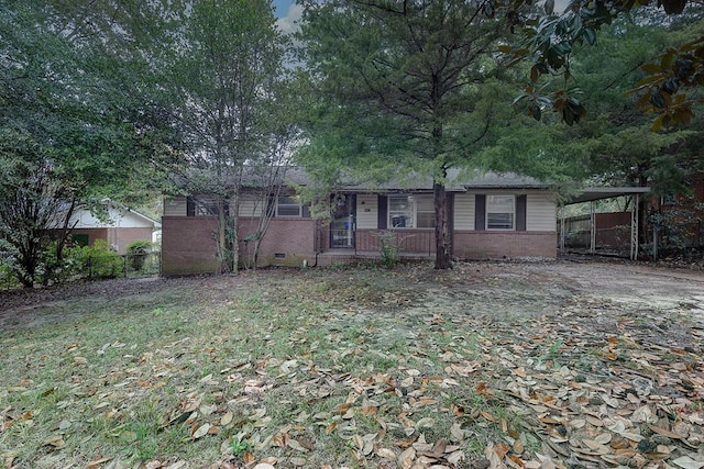 single story home with a front lawn and a carport