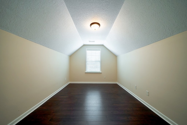 235 Pebblebrook Ln, Columbus, GA 31904 - bonus room with a textured ceiling, dark wood-type flooring, and vaulted ceiling