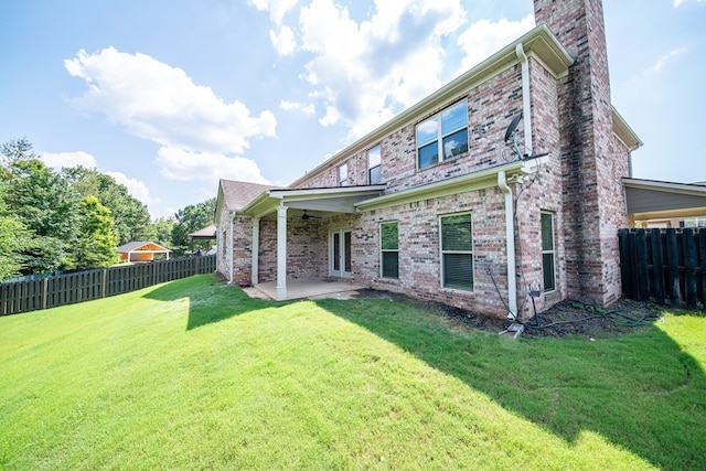 235 Pebblebrook Ln, Columbus, GA 31904 - back of house featuring a chimney, a patio area, a fenced backyard, a ceiling fan, and brick siding