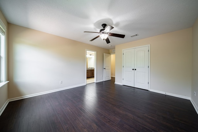235 Pebblebrook Ln, Columbus, GA 31904 - unfurnished bedroom featuring dark wood-style flooring, a closet, a ceiling fan, and ensuite bath