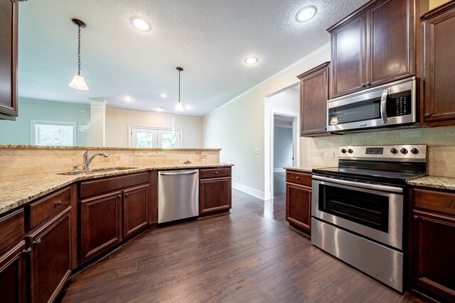 235 Pebblebrook Ln, Columbus, GA 31904 - kitchen featuring appliances with stainless steel finishes, decorative backsplash, dark wood finished floors, light stone countertops, and recessed lighting