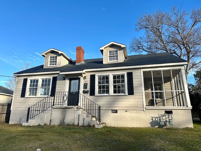 view of front of house with a front lawn and a sunroom