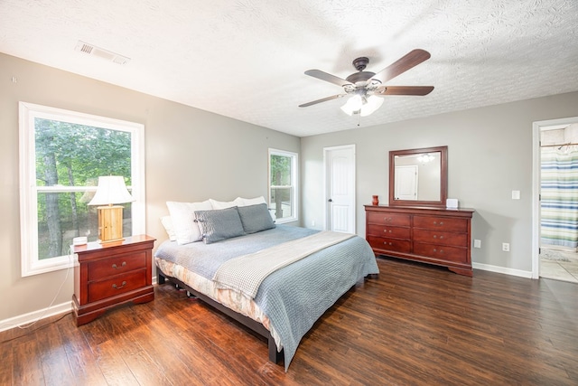 170 Slappy Dr, Hamilton, GA 31811 - bedroom featuring wood finished floors, multiple windows, ceiling fan, and a textured ceiling