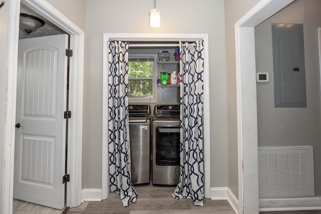 170 Slappy Dr, Hamilton, GA 31811 - laundry room with electric panel, washing machine and dryer, and wood finished floors
