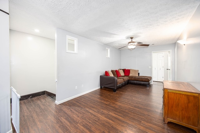 170 Slappy Dr, Hamilton, GA 31811 - living area with dark wood finished floors, ceiling fan, and a textured ceiling