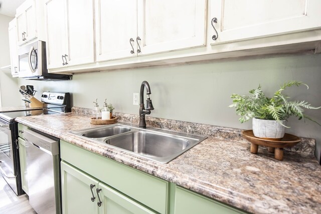 170 Slappy Dr, Hamilton, GA 31811 - kitchen featuring green cabinets, appliances with stainless steel finishes, light countertops, and white cabinets