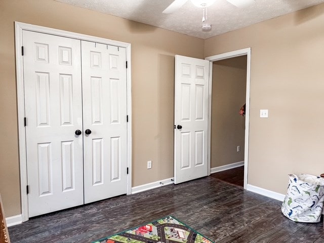 rec room with baseboards, a textured ceiling, wood finished floors, and a ceiling fan