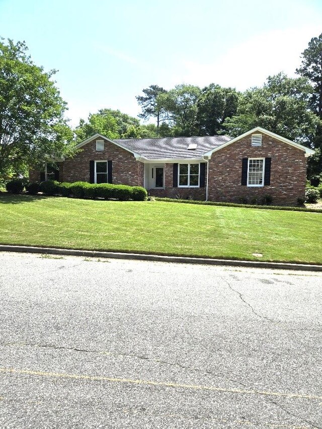 4044 Castlewood Pkwy, Columbus, GA 31907 - view of front facade with a front yard and brick siding