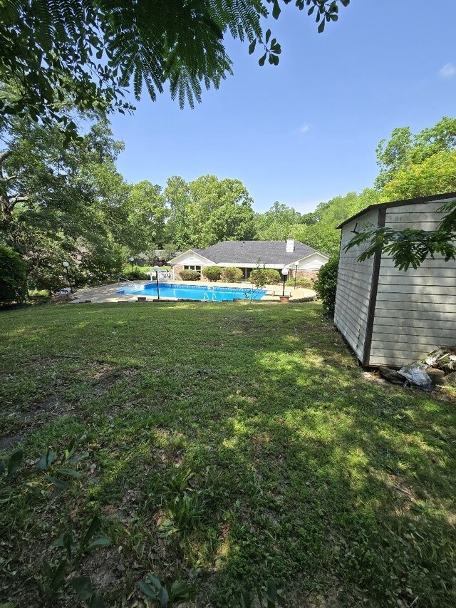 4044 Castlewood Pkwy, Columbus, GA 31907 - view of green lawn featuring an outdoor pool, an outdoor structure, and a storage unit