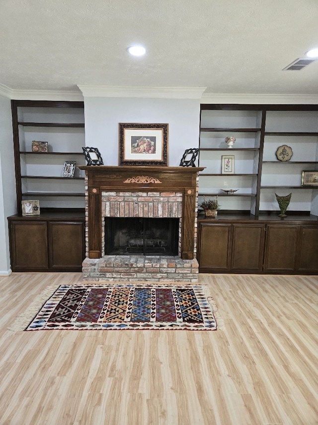 4044 Castlewood Pkwy, Columbus, GA 31907 - living area with wood finished floors, crown molding, a textured ceiling, and a brick fireplace