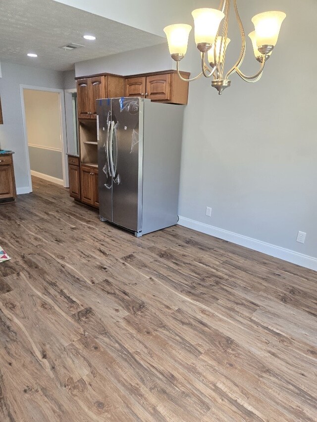 4044 Castlewood Pkwy, Columbus, GA 31907 - kitchen with freestanding refrigerator, baseboards, wood finished floors, a chandelier, and brown cabinetry