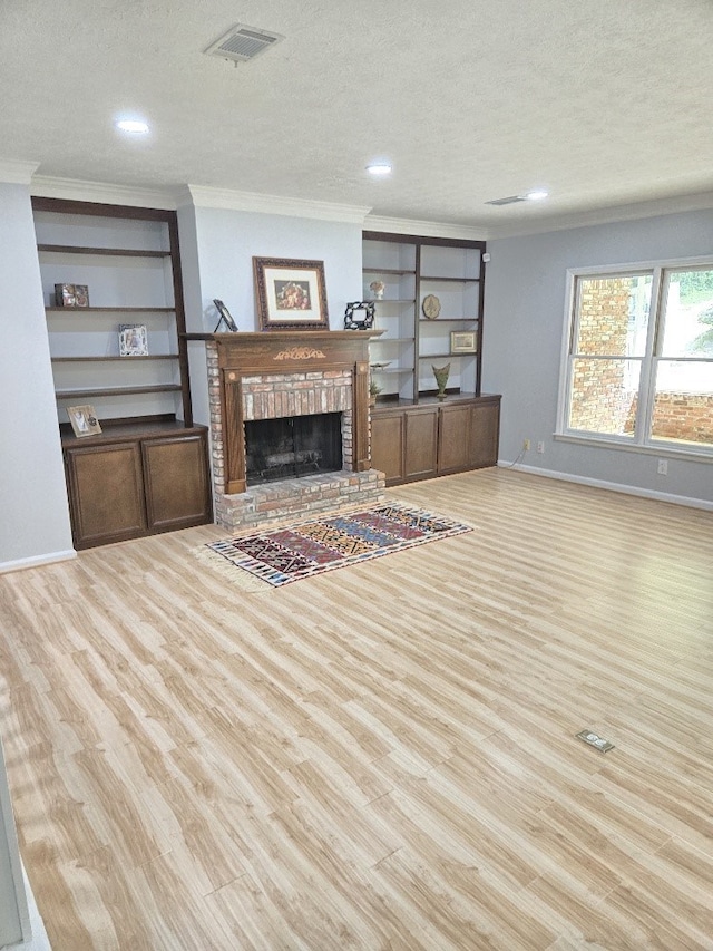 4044 Castlewood Pkwy, Columbus, GA 31907 - living room with a textured ceiling, wood finished floors, ornamental molding, a fireplace, and baseboards
