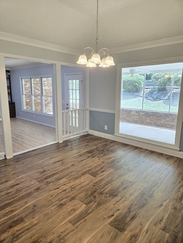 4044 Castlewood Pkwy, Columbus, GA 31907 - unfurnished dining area featuring ornamental molding, a chandelier, dark wood-style floors, and plenty of natural light