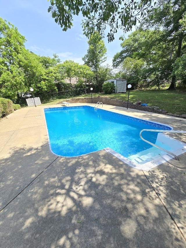 4044 Castlewood Pkwy, Columbus, GA 31907 - view of swimming pool featuring a patio area, a storage unit, an outbuilding, and a yard