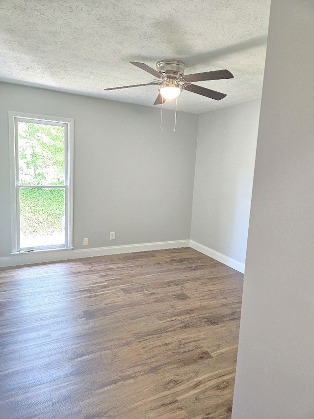 4044 Castlewood Pkwy, Columbus, GA 31907 - spare room with wood finished floors, a ceiling fan, baseboards, and a textured ceiling
