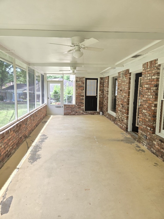 4044 Castlewood Pkwy, Columbus, GA 31907 - unfurnished sunroom with brick wall, a ceiling fan, and concrete flooring