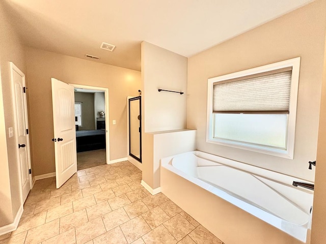 3814 Pond View Ct, Columbus, GA 31907 - ensuite bathroom featuring a bath, a stall shower, and baseboards