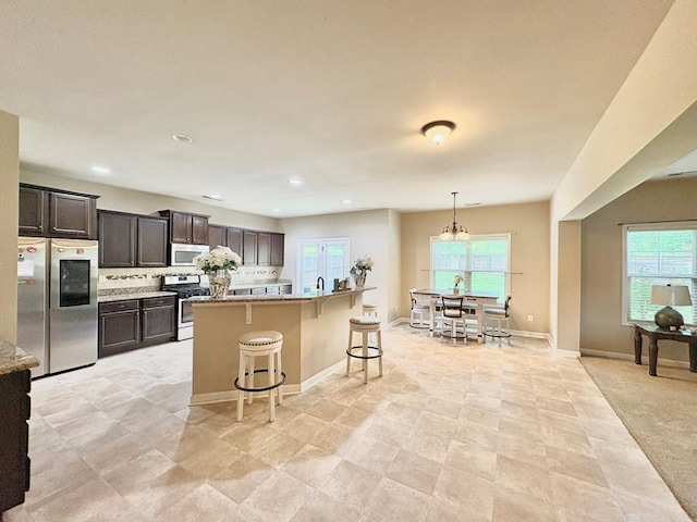 3814 Pond View Ct, Columbus, GA 31907 - kitchen featuring stainless steel appliances, a breakfast bar area, light countertops, baseboards, and recessed lighting