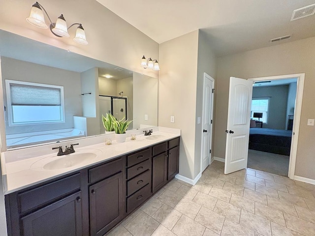 3814 Pond View Ct, Columbus, GA 31907 - ensuite bathroom featuring double vanity, baseboards, a shower stall, and a tub to relax in