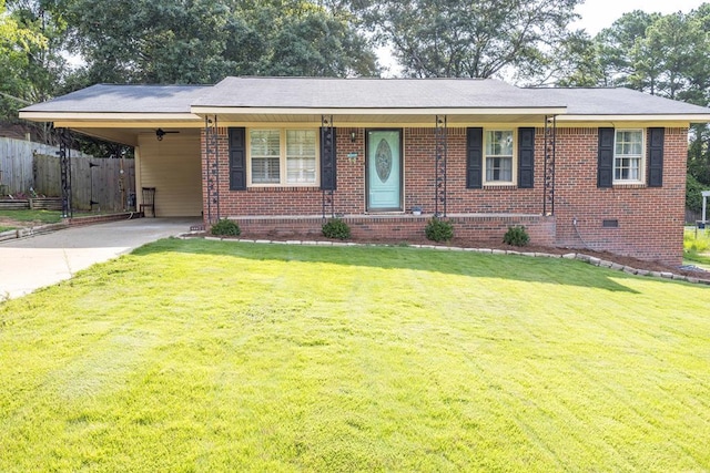 ranch-style house featuring a carport and a front lawn