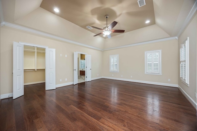 8758 Ga Highway 0315, Cataula, GA 31804 - unfurnished bedroom featuring a tray ceiling, wood finished floors, a spacious closet, a ceiling fan, and baseboards