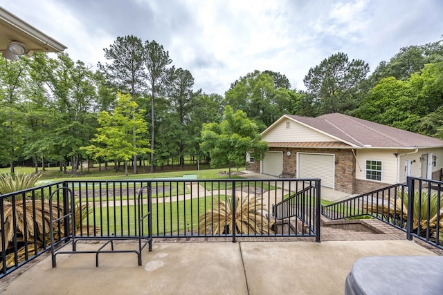 8758 Ga Highway 0315, Cataula, GA 31804 - view of patio / terrace with view of wooded area and an attached garage