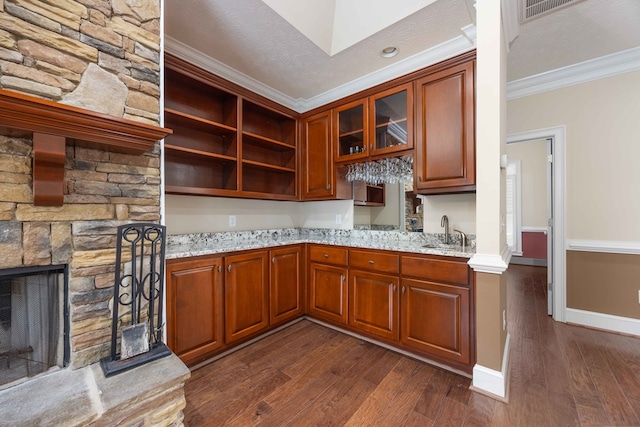 8758 Ga Highway 0315, Cataula, GA 31804 - kitchen with crown molding, dark wood finished floors, a sink, light stone countertops, and a stone fireplace