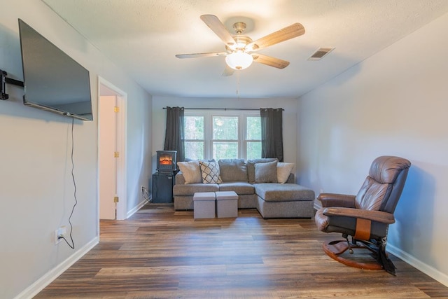 living room with dark hardwood / wood-style floors and ceiling fan