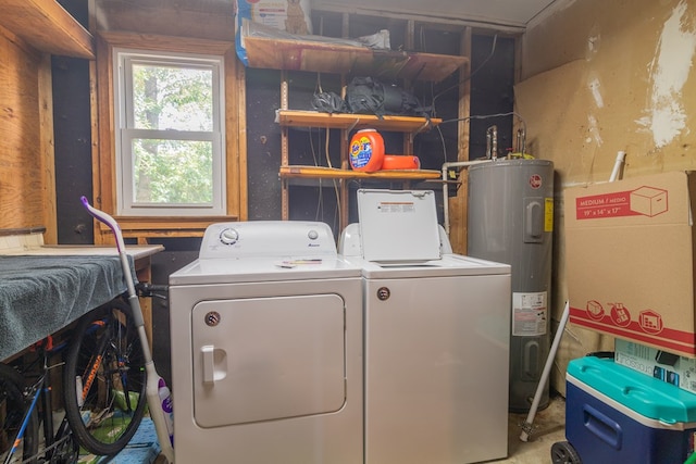 washroom with electric water heater and washer and clothes dryer