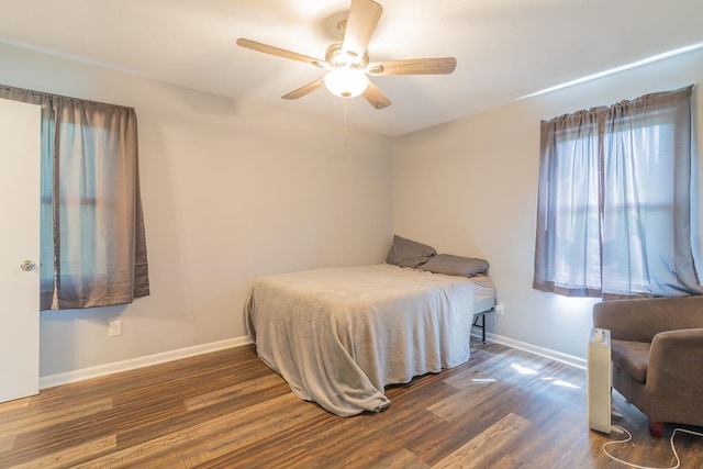 bedroom with ceiling fan and dark hardwood / wood-style floors